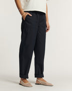Pantalon en popeline de coton bleu marine, coupe droite ample avec poches plaquées et revers aux chevilles, offrant un confort léger et une silhouette décontractée.