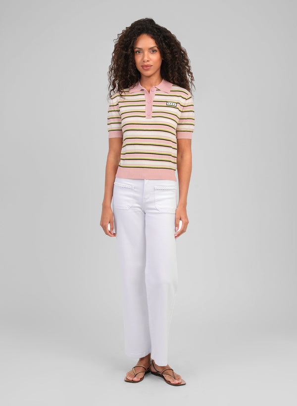 An'ge – Pitress White Trousers, female model wearing a pink and white striped polo shirt, white trousers