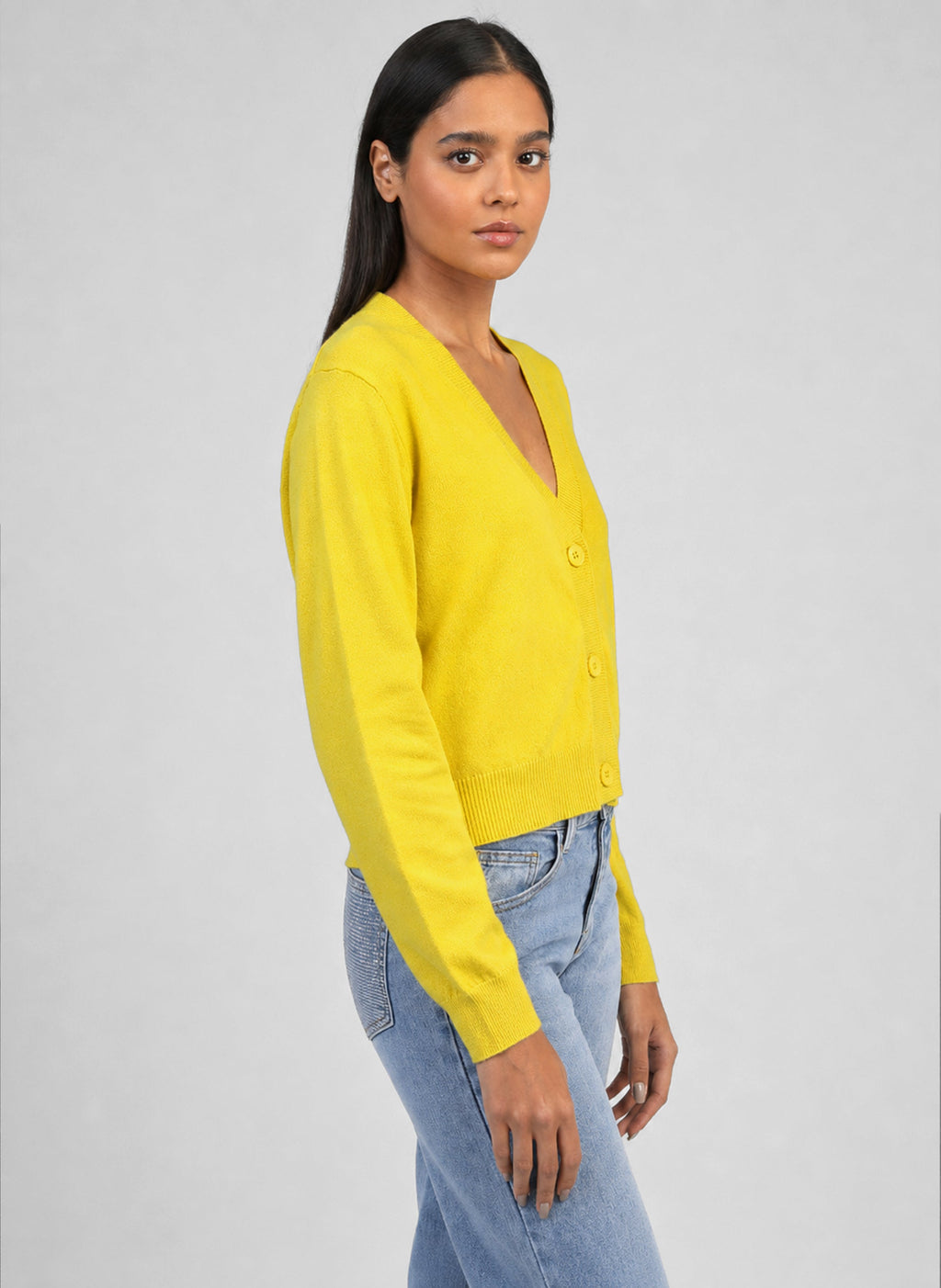 An'ge – Nalidye Cardigan Yellow, yellow cardigan worn by a model, side view, on a grey background