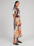 An'ge – Obemia Clever Ecru Maxi Dress, model wearing a colourful patterned maxi dress, side view
