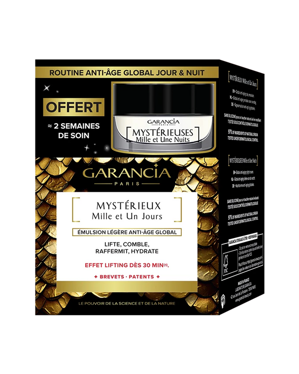 Embalaje de la caja dorada y negra que contiene el tarro de crema de día Mystérieux y una miniatura de noche gratis