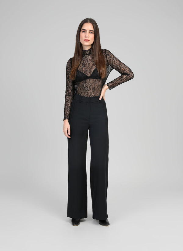 An'ge – Polidor Black trousers, female model wearing a black lace bodysuit and black trousers