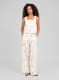 An'ge – Raiponce Trousers Ecru, female model wearing an ecru set with red floral print, front view