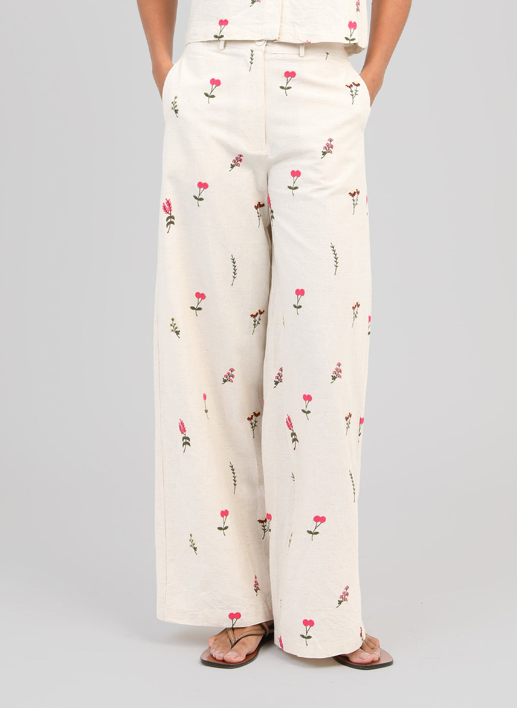 An'ge – Raiponce Trousers Ecru, ecru wide-leg trousers with pink floral print worn by a model
