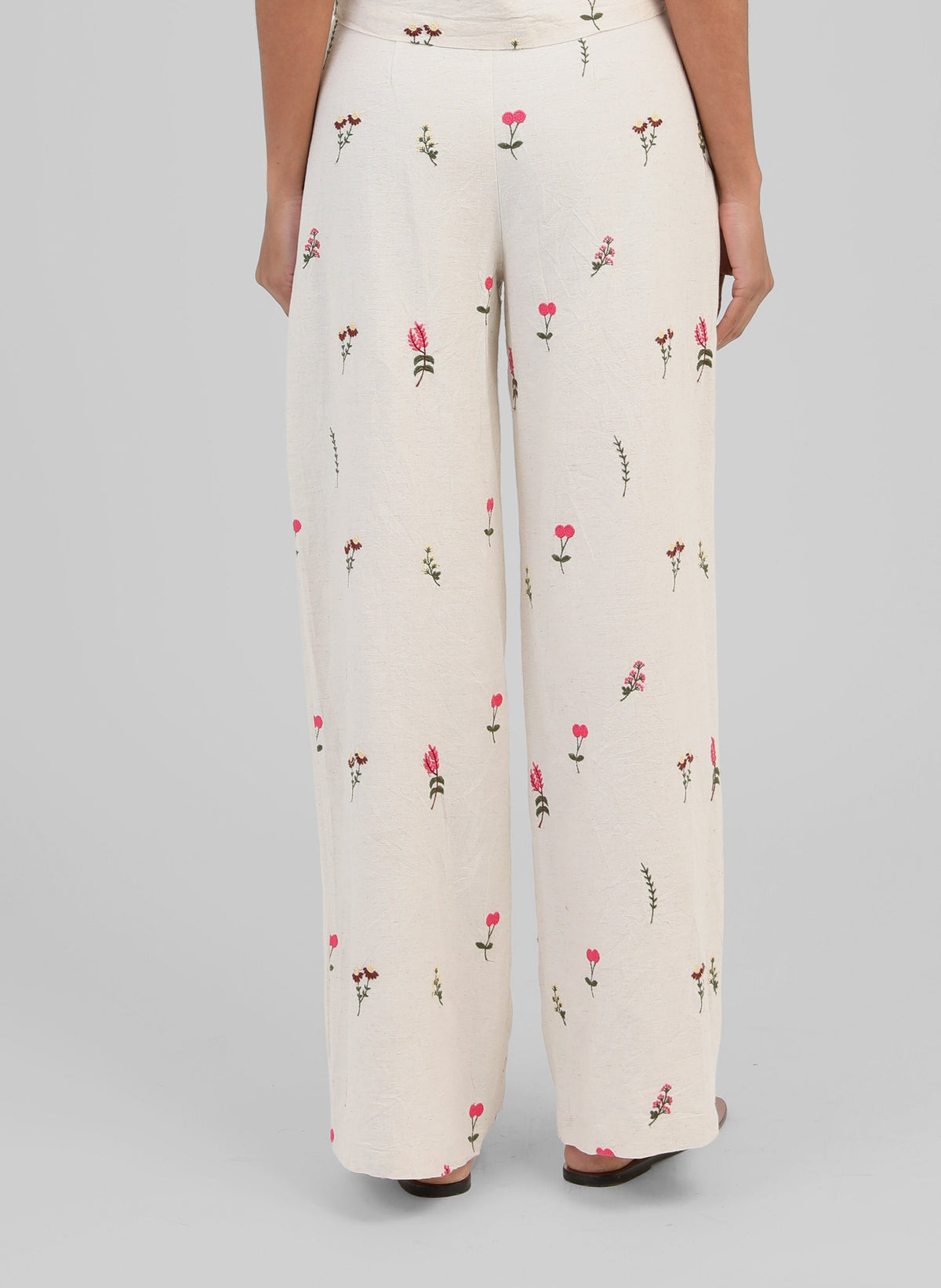 An'ge – Raiponce Trousers Ecru, ecru wide-leg trousers with pink and green floral print, back view