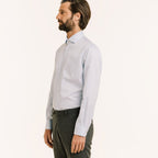 Hast – Two-Ply Twill Shirt in Sky Blue, blue shirt worn by a man in profile, grey trousers