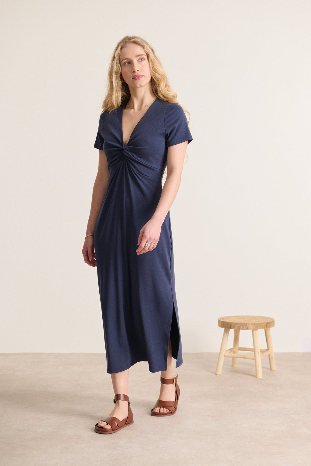 Flattering navy blue midi style with short sleeves, bow at chest, side slits