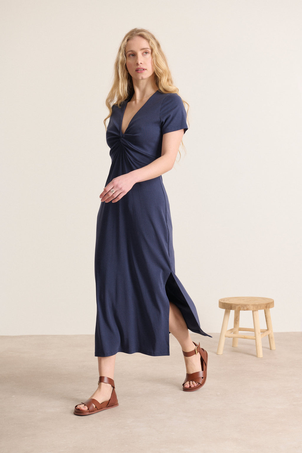 Elegant navy dress close to the body with a bow on the front and short sleeves, midi length cut, spring summer collection Garance Paris 