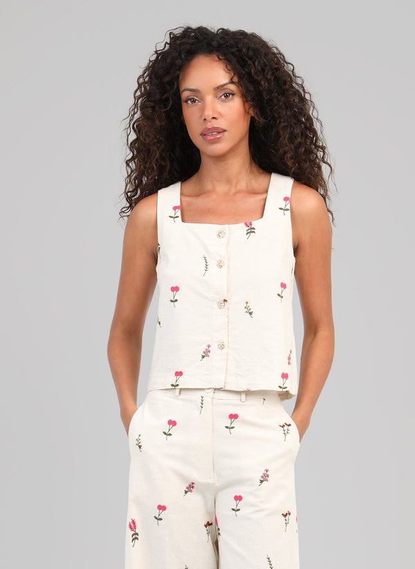 An'ge – Saddy Top Ecru, female model wearing an ecru set embroidered with pink flowers, front view