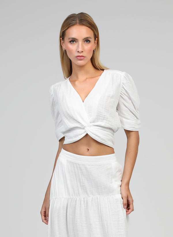 An'ge – Sadouma Off-White Wrap Top, model wearing a short-sleeved white crop top and a maxi skirt