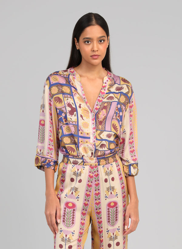 An'ge – Sylvanie Multi Top, female model wearing a shirt and trousers with colourful patterns, front view