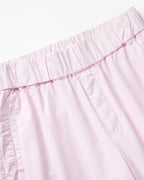 Light pink poplin pants with elastic waist, straight cut and visible stitching details for comfort and a casual look for women.