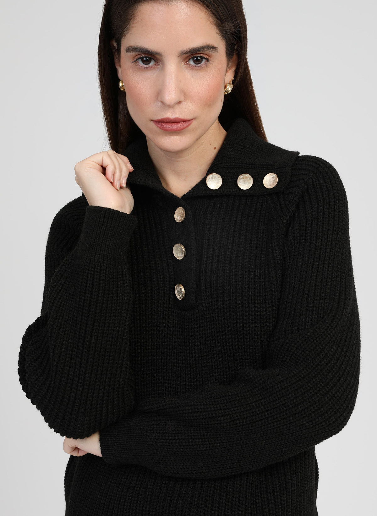 An'ge – Venise Noir Jumper, model wearing a black ribbed knit jumper with gold buttons