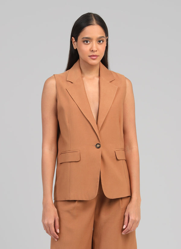 An'ge – Zakarita Suede Sleeveless Jacket, model wearing a light brown sleeveless blazer, front view