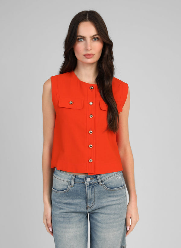An'ge – Zelia Sleeveless Jacket in Chilli, model wearing an orange sleeveless top with gold buttons, front view