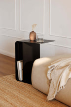 Beistelltisch COSMO aus pulverbeschichtetem Metall in modernem Design neben Sofa mit Deko