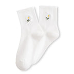 Chaussette haute unie avec marguerite brodée.