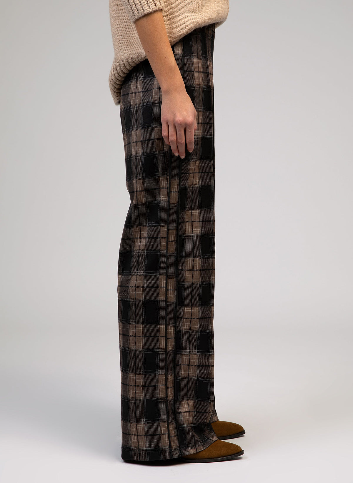 An'ge – Patrila Brown Trousers, brown and black checked trousers worn by a model, side view