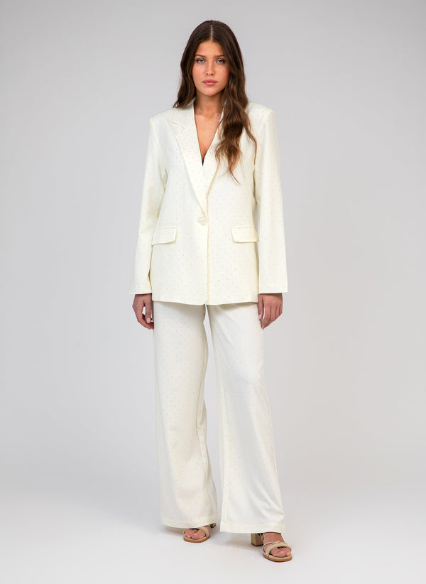 An'ge – Pelina Ecru Trousers, model wearing an off-white blazer and trousers set, front view