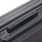 Asa superior rígida de la maleta GYL Intemporelle gris oscuro con logo en relieve en la parte superior. #couleur_gris foncé