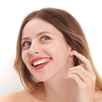 Coral shade of the natural and clean Pomponne lipstick on fair skin