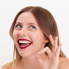 Plum shade of the natural and clean Pomponne lipstick on fair skin