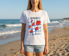 Clementina Italy Pomodoro T-shirt on beach. Relaxed Mediterranean vibe.